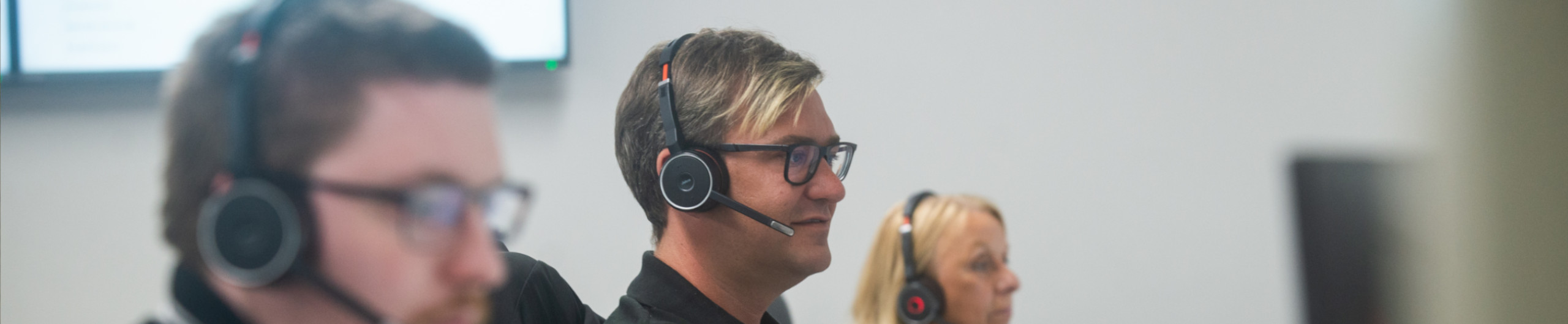 Customer service team wearing telephone headset